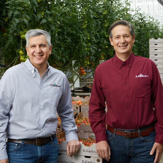 Growers standing in front of produce